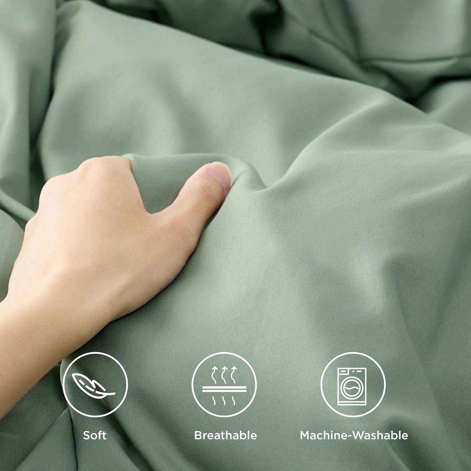 Hand touching a sage green bamboo fabric, showcasing its softness, breathability, and machine-washable properties with icons