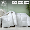 Image showcasing a luxurious white Organic Bamboo Microfibre Quilt on a neatly made bed with beige pillows. The background features a green wall and a plant, emphasizing the comforter's eco-friendly nature. The comforter is labeled as 100% natural organic product. Payment options available are Apple Pay, PayPal, and Shop Pay