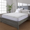 A modern bedroom with a grey wooden bed frame featuring Adorearth's Pure Bamboo mattress topper, highlighted by white bedding and pillows, and a plant in the background, showcasing the eco-friendly and luxurious design.