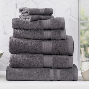 Stack of Adorearth™ organic bamboo towels in grey color against a white tiled background