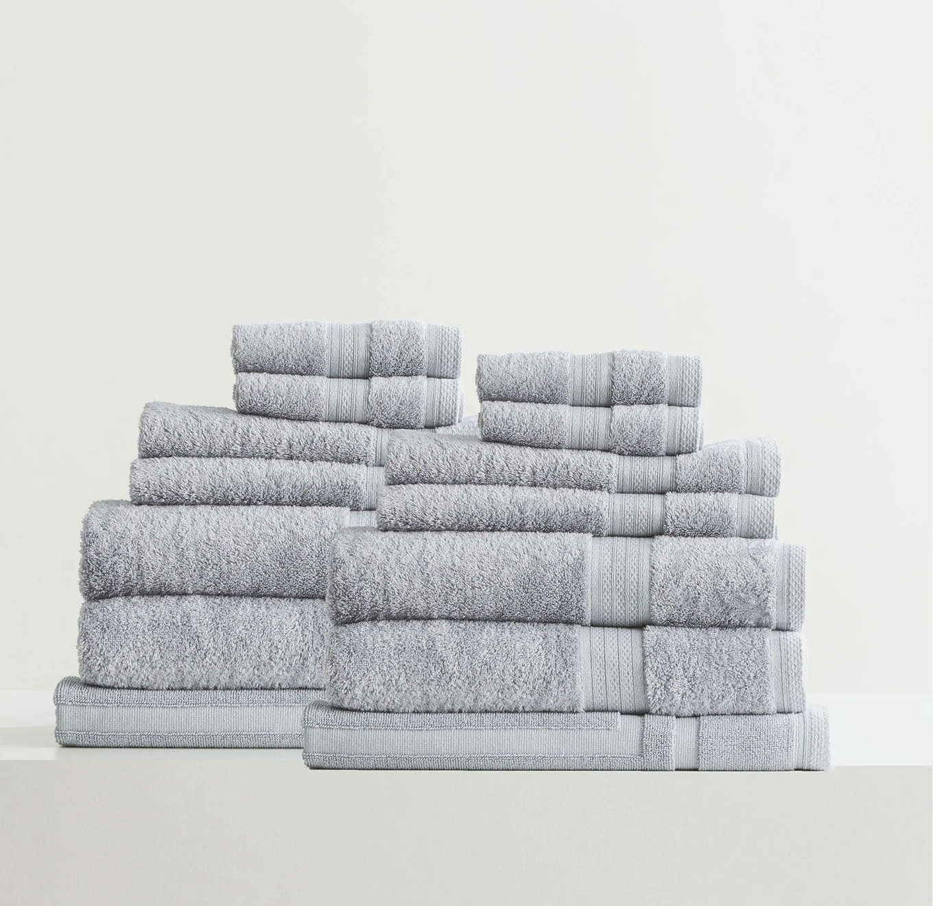 Adorearth™ organic bamboo towels in grey neatly stacked in a set.