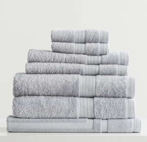 A stack of soft, gray Adorearth™ organic bamboo towels on a white surface